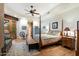 Spacious bedroom with hardwood floors and a charming four-poster bed at 34587 N Ironwood Rd, Scottsdale, AZ 85266