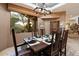 Formal dining room with a view, wood table and chairs, and a rustic cabinet at 34587 N Ironwood Rd, Scottsdale, AZ 85266
