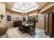 Elegant dining room with a large window, chandelier, and hardwood floors at 34587 N Ironwood Rd, Scottsdale, AZ 85266