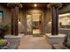 Grand entry with wood columns, stone flooring, and stained-glass door at 34587 N Ironwood Rd, Scottsdale, AZ 85266