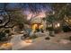 Front entry with curved pathway, desert landscaping, and lighting at 34587 N Ironwood Rd, Scottsdale, AZ 85266