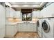 Bright laundry room, featuring washer, dryer and ample cabinetry at 34587 N Ironwood Rd, Scottsdale, AZ 85266