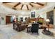Large living room with a stone fireplace and high ceilings, multiple seating areas at 34587 N Ironwood Rd, Scottsdale, AZ 85266