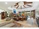 Open floor plan living room with a stone fireplace and access to backyard at 34587 N Ironwood Rd, Scottsdale, AZ 85266