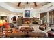 Spacious living room with a large stone fireplace and high ceilings at 34587 N Ironwood Rd, Scottsdale, AZ 85266