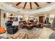 Open living room with leather sofas and a large stone fireplace at 34587 N Ironwood Rd, Scottsdale, AZ 85266
