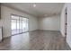 Bright living room with sliding glass doors and wood-look flooring at 353 Ancora S Dr, Litchfield Park, AZ 85340