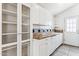 White kitchen with tile backsplash and glass-front cabinets at 4129 N 17Th St, Phoenix, AZ 85016