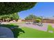 Landscaped backyard with artificial turf and patio at 4222 E Mclellan Cir # 7, Mesa, AZ 85205