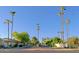 Community entrance with palm trees and gated entry at 4222 E Mclellan Cir # 7, Mesa, AZ 85205