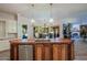 Open kitchen with large island, breakfast bar, and views to backyard at 4222 E Mclellan Cir # 7, Mesa, AZ 85205