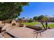 Relaxing stone patio with fire feature and landscaping at 4222 E Mclellan Cir # 7, Mesa, AZ 85205