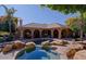 Inviting pool and spa surrounded by rocks and landscaping at 4222 E Mclellan Cir # 7, Mesa, AZ 85205