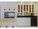 Wet bar with granite countertop and glass-front cabinetry at 4222 E Mclellan Cir # 7, Mesa, AZ 85205