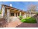 Back exterior of house with covered patio, brick pavers, and a grassy yard at 4239 E Wildcat Dr, Cave Creek, AZ 85331