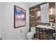 Small bathroom with an exposed brick wall and marble vanity at 4515 N 36Th Way, Phoenix, AZ 85018