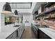 Modern kitchen features a large island, stainless steel appliances, and exposed brick at 4515 N 36Th Way, Phoenix, AZ 85018