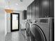 Clean laundry room with modern washer and dryer, dark cabinets, and geometric floor tiles at 4515 N 36Th Way, Phoenix, AZ 85018