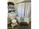 Updated bathroom with a tub, toilet, and shelving at 524 W Fairway Dr # 12, Mesa, AZ 85201