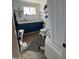 Bathroom with a white tub, blue vanity, and wood-look flooring at 524 W Fairway Dr # 12, Mesa, AZ 85201