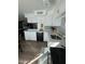 Modern kitchen with white cabinets, quartz countertops, and black appliances at 524 W Fairway Dr # 12, Mesa, AZ 85201
