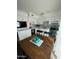 Eat-in kitchen with white cabinets, mosaic backsplash and wood flooring at 524 W Fairway Dr # 12, Mesa, AZ 85201