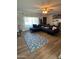 Living room features a sectional sofa, wood flooring, and a ceiling fan at 524 W Fairway Dr # 12, Mesa, AZ 85201