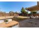 Private backyard with covered patio, lawn area, and seating at 5518 W Mercury Way, Chandler, AZ 85226