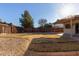 Sunny backyard with gravel, grass, and a wooden fence at 5518 W Mercury Way, Chandler, AZ 85226
