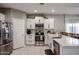 Modern kitchen with stainless steel appliances and white cabinets at 5523 W Chuck Box Rd, Laveen, AZ 85339