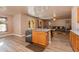 Open kitchen with island and view into living room at 5731 W Aster Dr, Glendale, AZ 85304