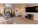 Living room with comfortable seating, large TV, and access to the entryway at 5731 W Aster Dr, Glendale, AZ 85304