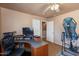 Home office with corner desk and exercise equipment at 5731 W Aster Dr, Glendale, AZ 85304