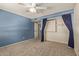 Spacious bedroom with blue walls and ample closet space at 6113 W Desert Hills Dr, Glendale, AZ 85304