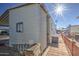 Rear view of manufactured home with ac unit and walkway at 7750 E Broadway Rd # 495, Mesa, AZ 85208