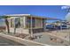 Single-wide manufactured home with covered carport and landscaped yard at 7750 E Broadway Rd # 495, Mesa, AZ 85208