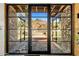 View of mountain landscape through modern glass entry doors at 11098 E Whistling Wind Way # 1851, Scottsdale, AZ 85255