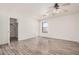 Bedroom with wood floors, ceiling fan, and walk-in closet at 11514 W Charter Oak Rd, El Mirage, AZ 85335