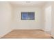 Simple bedroom with wood floors and window at 11514 W Charter Oak Rd, El Mirage, AZ 85335