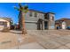 Two-story house with gray siding, attached garage, and landscaping at 11514 W Charter Oak Rd, El Mirage, AZ 85335