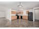 Kitchen with light wood cabinets, black appliances, and tile floor at 11514 W Charter Oak Rd, El Mirage, AZ 85335