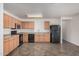 Kitchen with wood cabinets, black appliances, and tile floors at 11514 W Charter Oak Rd, El Mirage, AZ 85335