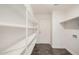 Laundry room with ample shelving and built-in storage at 11514 W Charter Oak Rd, El Mirage, AZ 85335