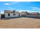 Large gravel backyard with block wall and access to the home at 11782 W Columbine Dr, El Mirage, AZ 85335