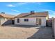 Spacious backyard with gravel, block wall, and sliding glass door access at 11782 W Columbine Dr, El Mirage, AZ 85335