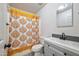 Clean bathroom with gray vanity and patterned shower curtain at 11782 W Columbine Dr, El Mirage, AZ 85335