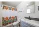 Bathroom with gray vanity and patterned shower curtain at 11782 W Columbine Dr, El Mirage, AZ 85335