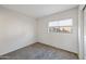 Bright bedroom with window and neutral colored carpet at 11782 W Columbine Dr, El Mirage, AZ 85335