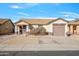 Single-story home with a two-car garage and landscaped front yard at 11782 W Columbine Dr, El Mirage, AZ 85335