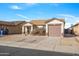 Single-story home with a two-car garage and landscaped front yard at 11782 W Columbine Dr, El Mirage, AZ 85335